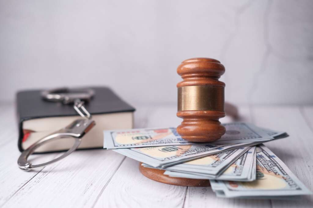 Justice, Money, and Law A Conceptual Still Life Featuring a Gavel Alongside Cash and Coins